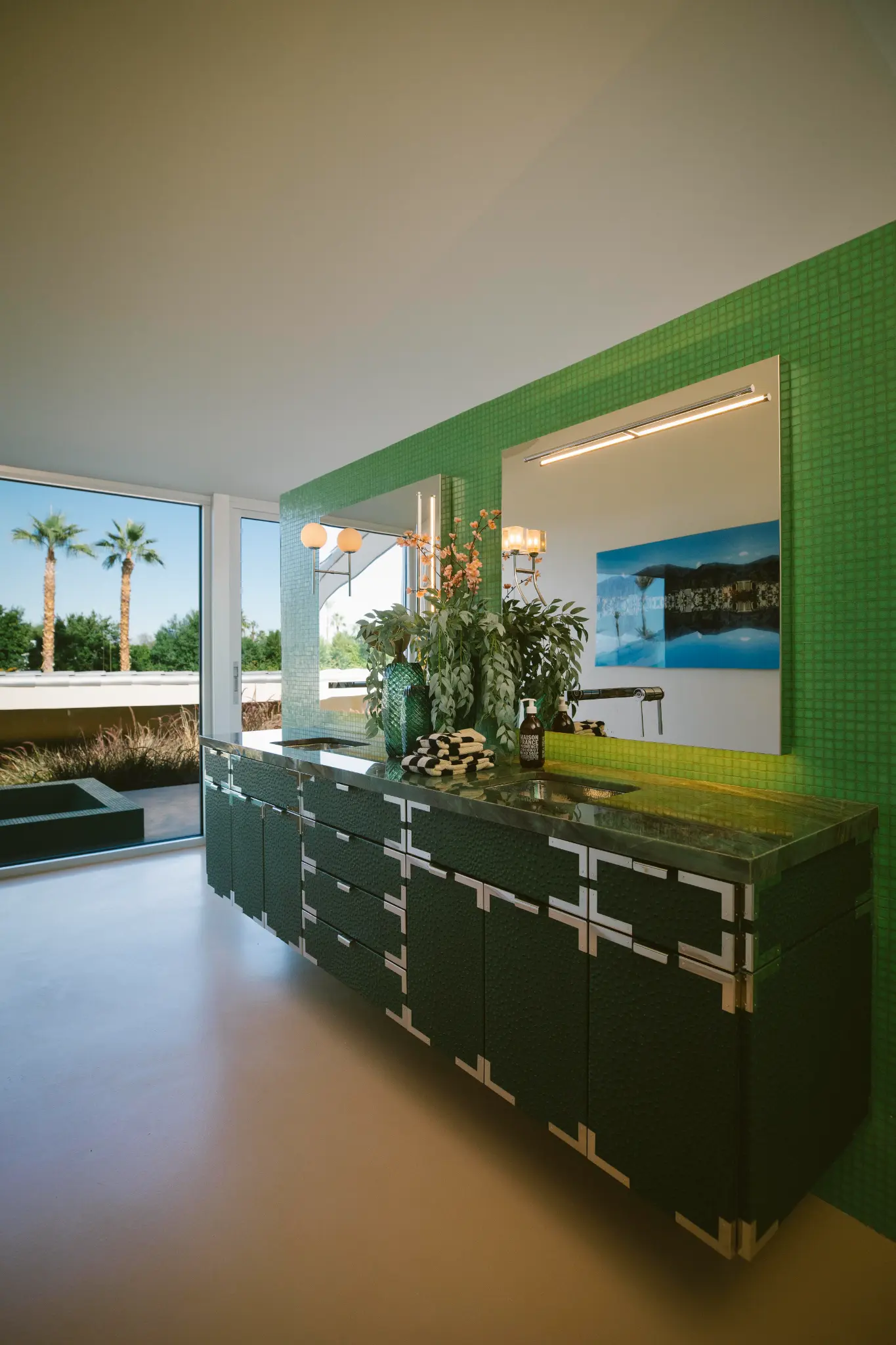 Primary bathroom at The Dreamer Estate with green tile and a custom vanity.
